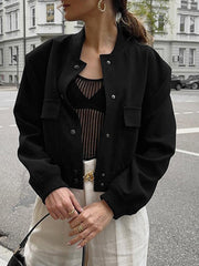 Black bomber jacket with button closure, chest pockets, and ribbed cuffs.