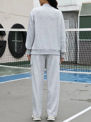 Light gray dropped shoulder sweater and cargo pants set.