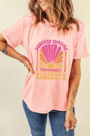 Watermelon pink graphic tee with a sunset design and "Forever Chasing Sunsets" text.