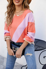 Diagonal colorblock knit sweater in orange or coral, acrylic.