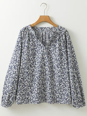 Blouse with allover floral print, V-neck, and long sleeves.