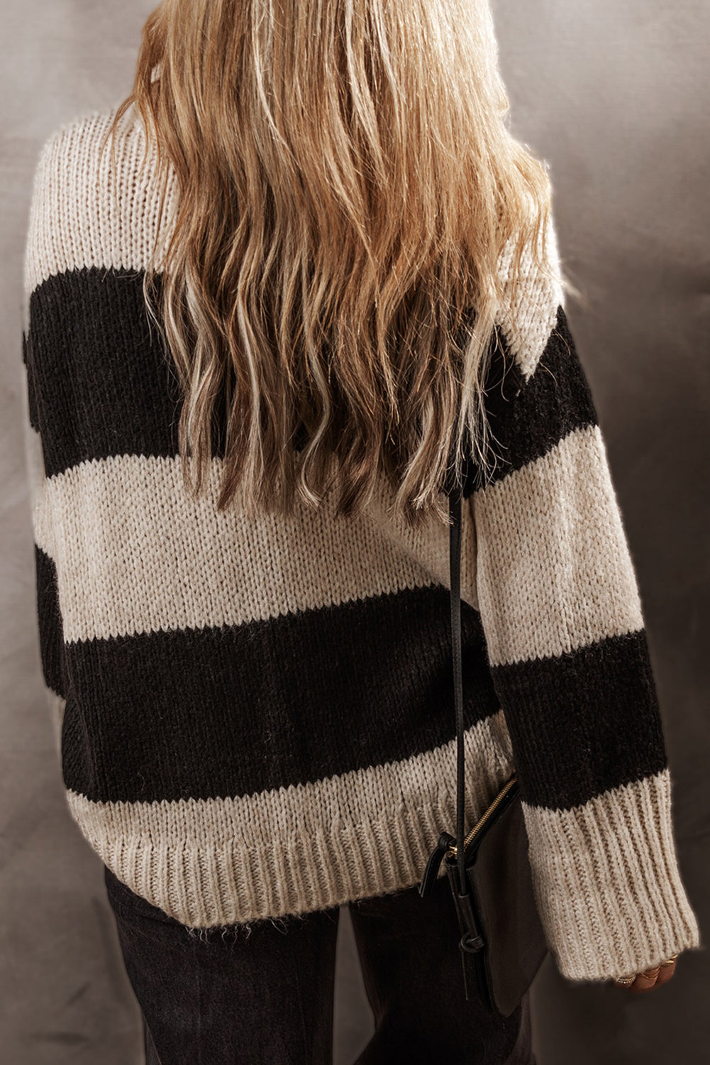Relaxed fit knit sweater in black and cream bold stripes, acrylic blend.