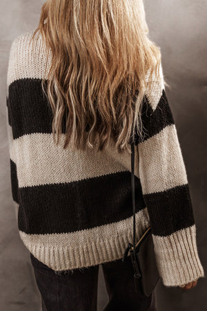 Relaxed fit knit sweater in black and cream bold stripes, acrylic blend.