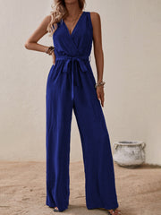 Textured wrap-front wide-leg jumpsuit in indigo with a tie waist and V-neck.
