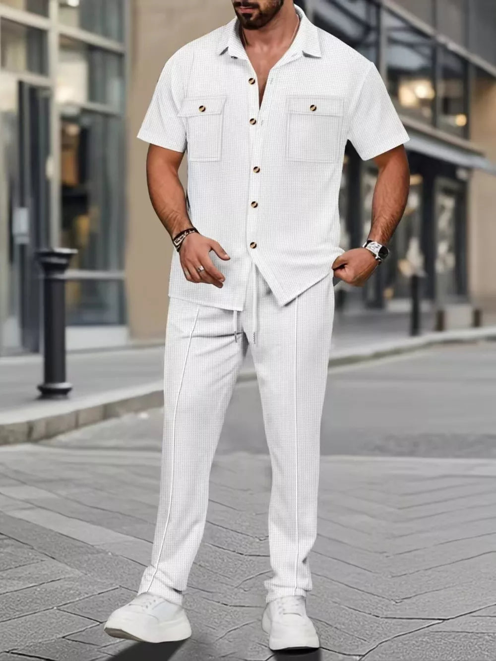 White textured short-sleeve button-up shirt with two chest pockets and matching drawstring pants.