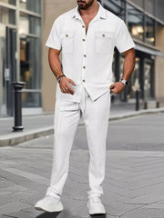 White textured short-sleeve button-up shirt with two chest pockets and matching drawstring pants.