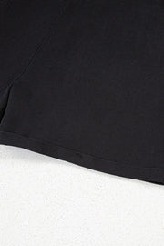 Black denim romper shorts with adjustable straps and cuffed hem