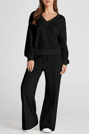Black V-neck loungewear set with seam detail pants and relaxed fit top