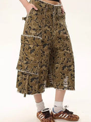 Men's distressed camo denim cargo shorts with frayed hem and pockets.
