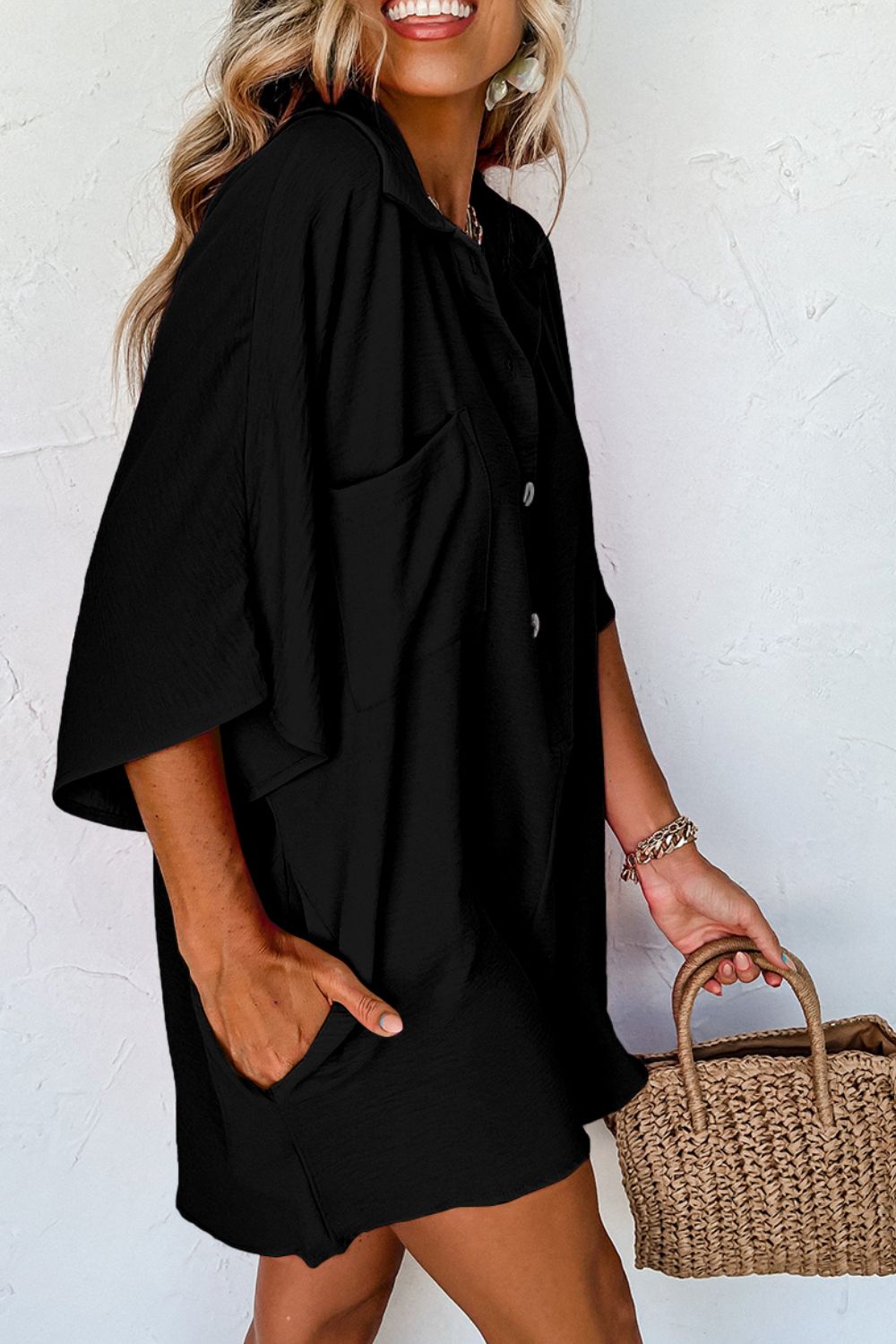 Black oversized shirt romper with pockets and button detail