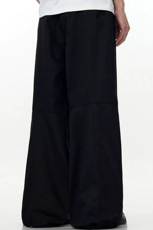 Men's black wide leg casual cargo pants with a relaxed fit.