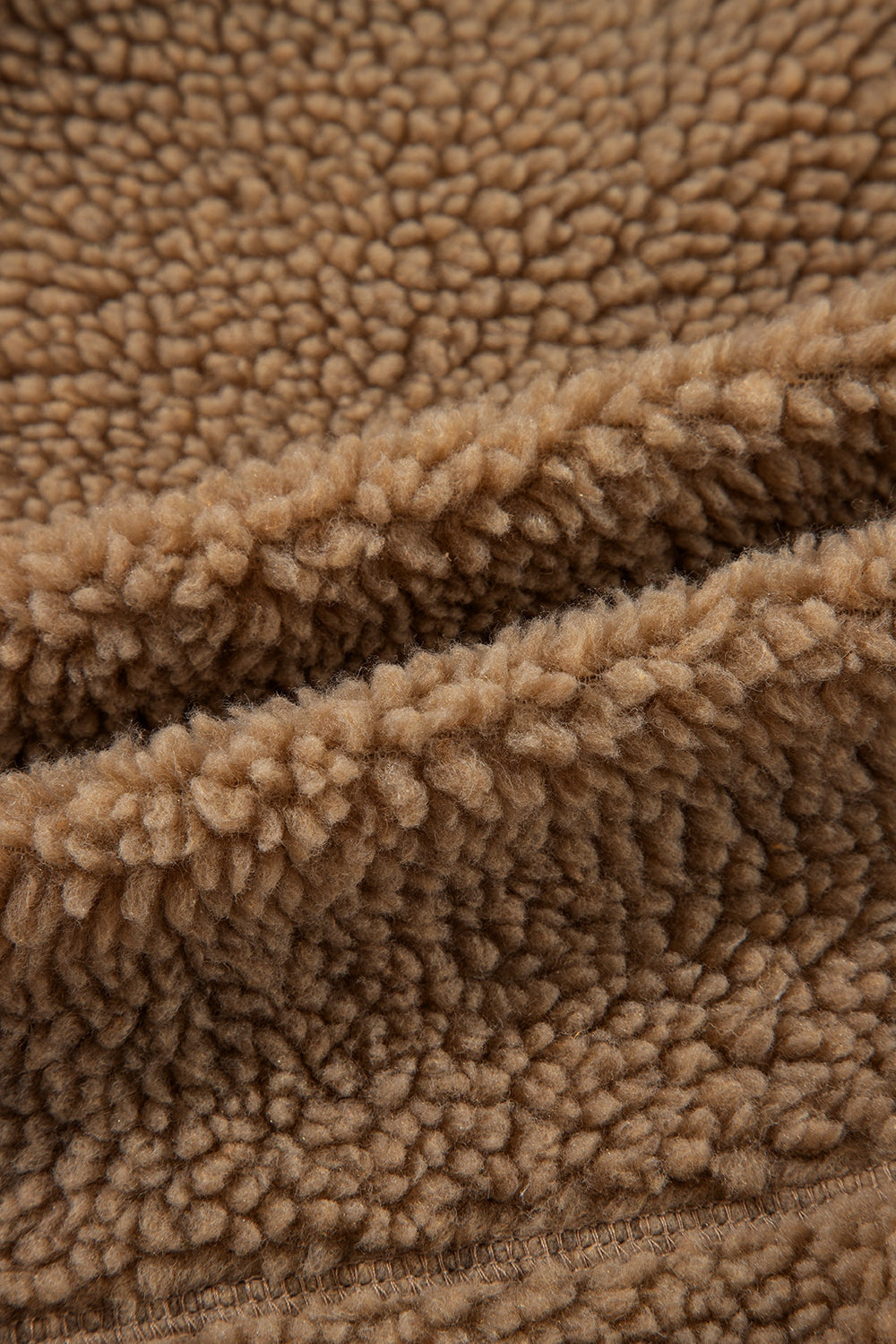 Brown sherpa jacket lining detail, soft fuzzy texture