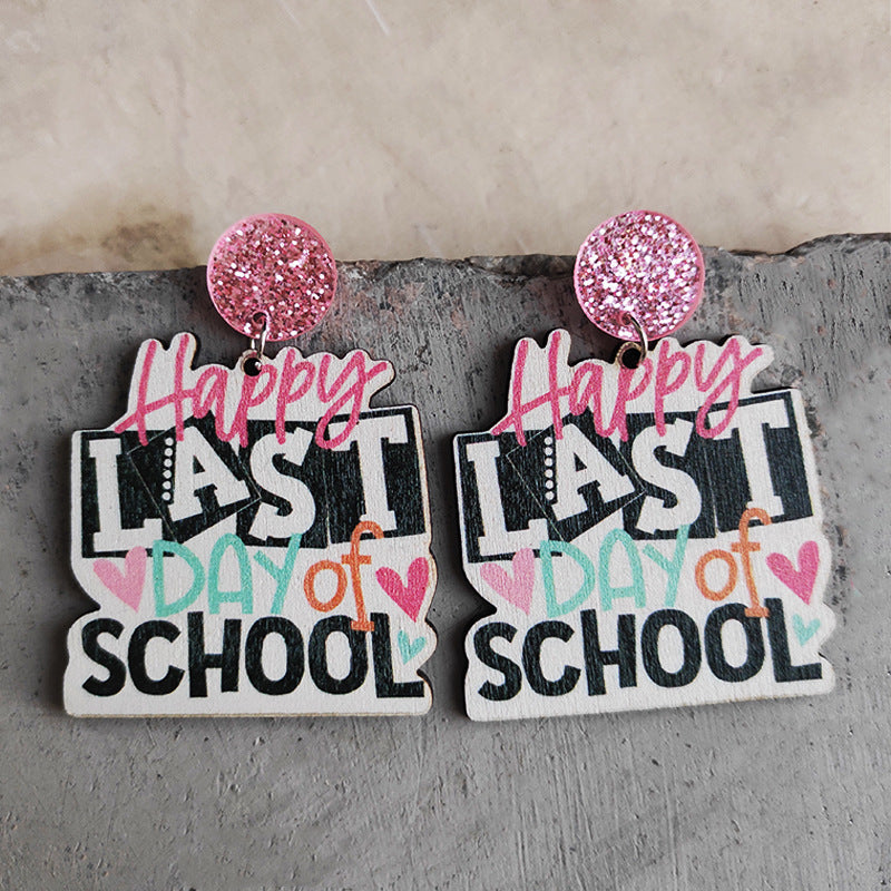 Graduation stacked book drop earrings with pink glitter tops and "Happy Last Day of School" text.