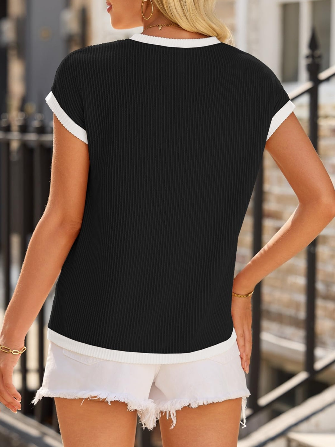 Black ribbed knit tee with white contrast piping and trim.