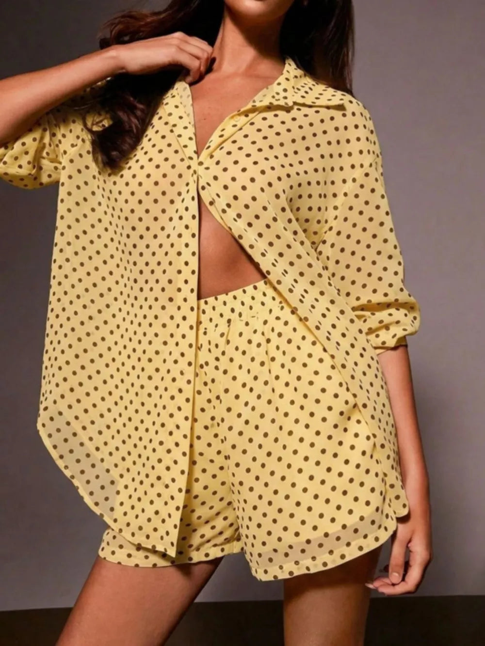 Yellow polka dot sheer two-piece set with collared button-up shirt and shorts.