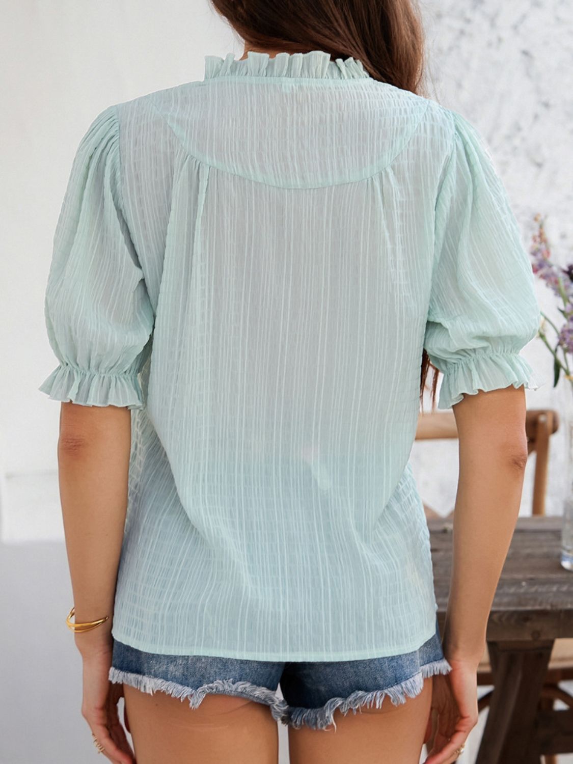 Light Green textured puff sleeve blouse with ruffled neckline and cuffs.