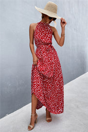 Red floral print halter maxi dress with a tiered skirt and tie waist.