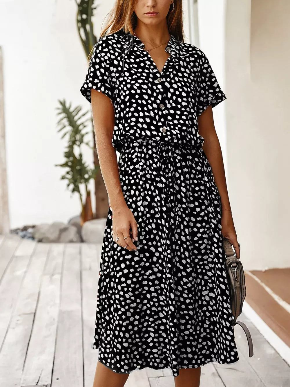 Midi dress with animal print, tied waist, button-down front, and short sleeves.