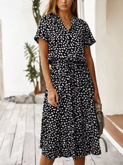 Midi dress with animal print, tied waist, button-down front, and short sleeves.