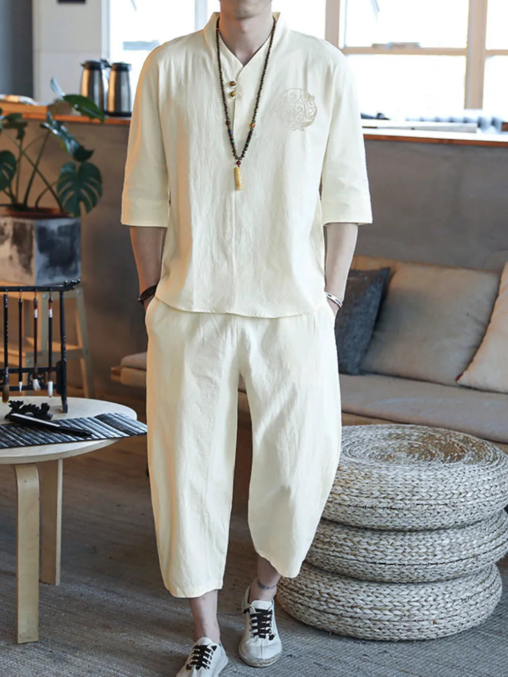 Men's relaxed 3/4 sleeve pants set in cream, featuring a V-neck top with button closure and embroidered detail.