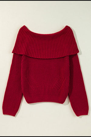 Deep red acrylic off-the-shoulder sweater with ribbed texture and a wide collar detail.