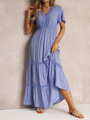 Blue lace-embellished tiered maxi dress with V-neck and short sleeves.