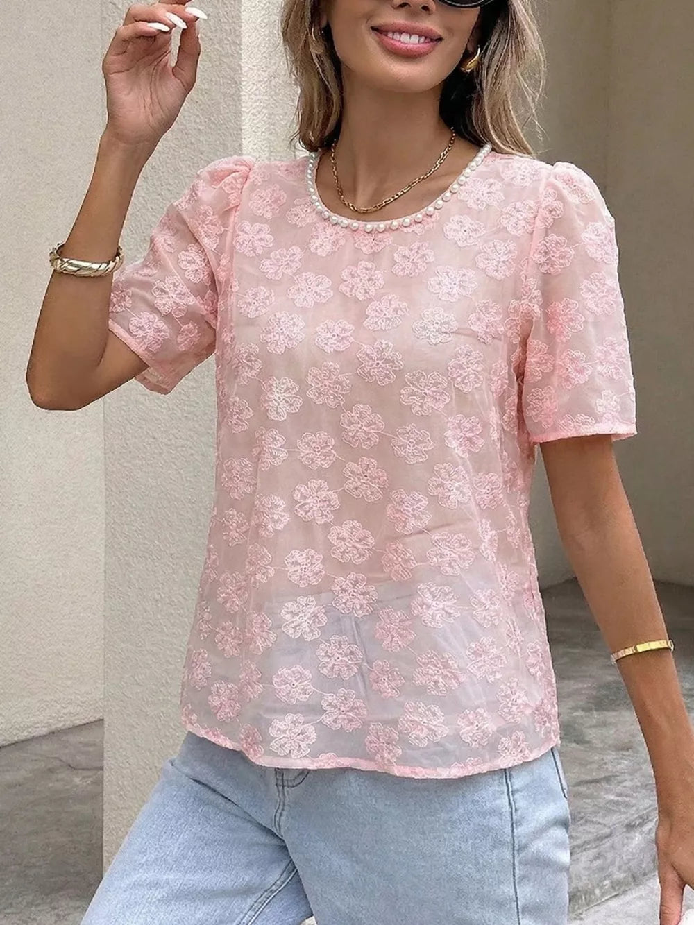 Pink embroidered floral sheer blouse with pearl trim and puff sleeves.