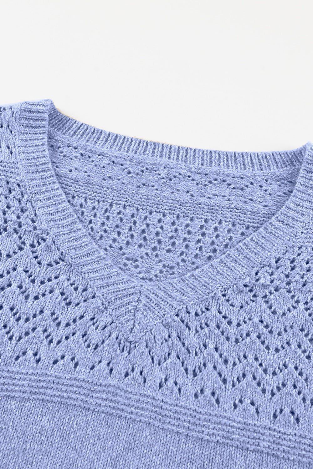 Light blue perforated knit v-neck pullover sweater with openwork detail.