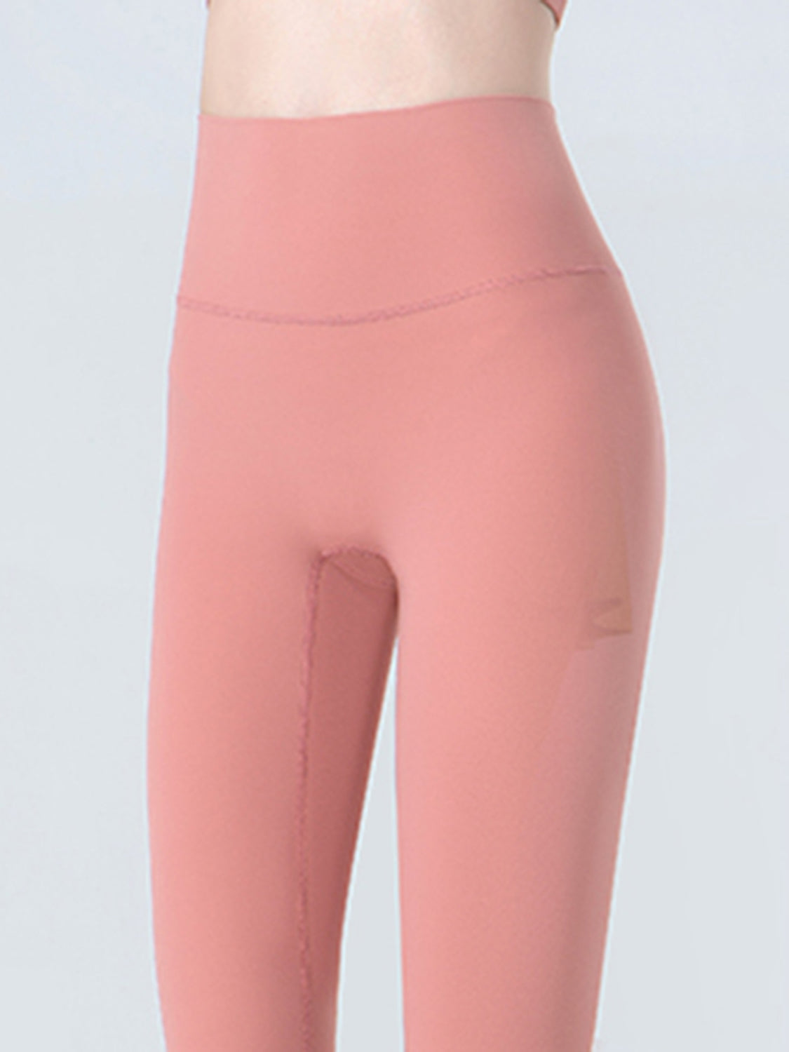 Sculpted crop leggings in coral with subtle mesh detail on the side.