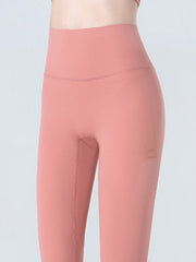Sculpted crop leggings in coral with subtle mesh detail on the side.