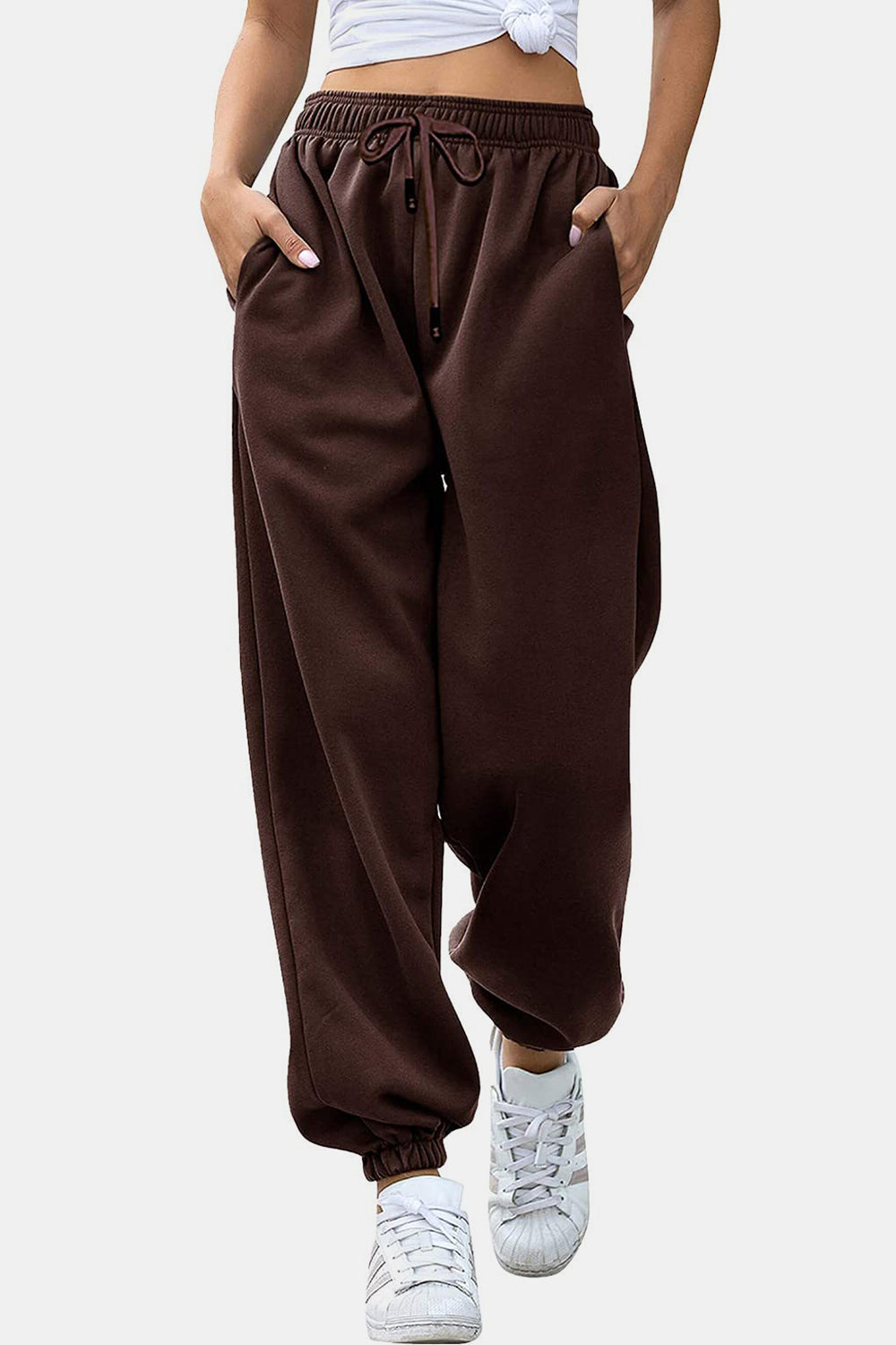 Relaxed-fit cuffed sweatpants in chocolate brown with drawstring waist and pockets.