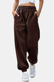 Relaxed-fit cuffed sweatpants in chocolate brown with drawstring waist and pockets.