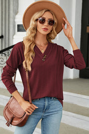 Burgundy textured cable-knit henley pullover with v-neck and button detail