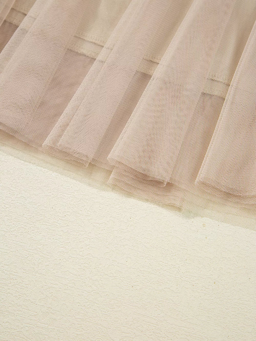 Lace overlay flared midi skirt in beige with textured fabric detail.