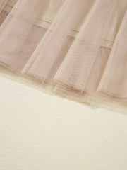 Lace overlay flared midi skirt in beige with textured fabric detail.