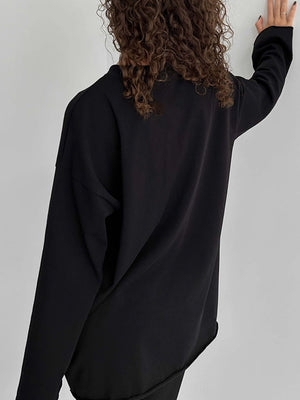 Oversized black cotton jersey top with long sleeves and a relaxed fit.