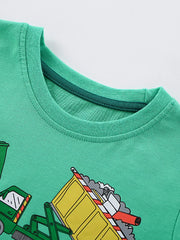 Green cotton t-shirt with a whimsical truck print and a dark green ribbed neckline.