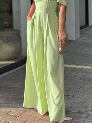 Lime green romper with cinched waist, deep V-neck, and puff sleeves.