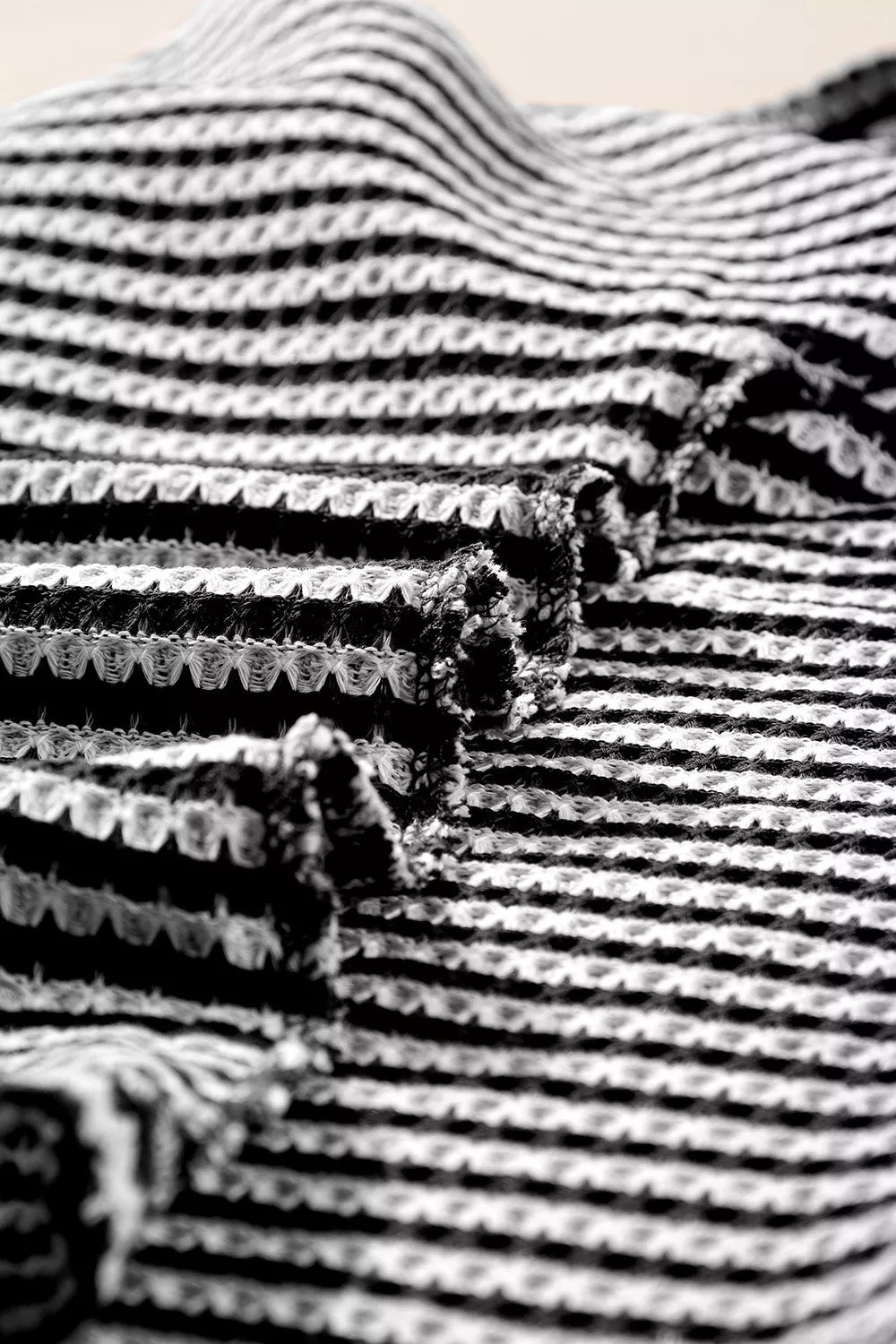 Textured knit t-shirt with horizontal stripes and a waffle weave pattern.
