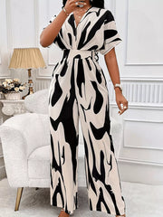 Black and white abstract print wide-leg romper with short sleeves and a V-neck.