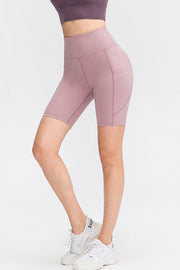 Sculpting pocketed cycling shorts in lavender with a high waist and side pockets.