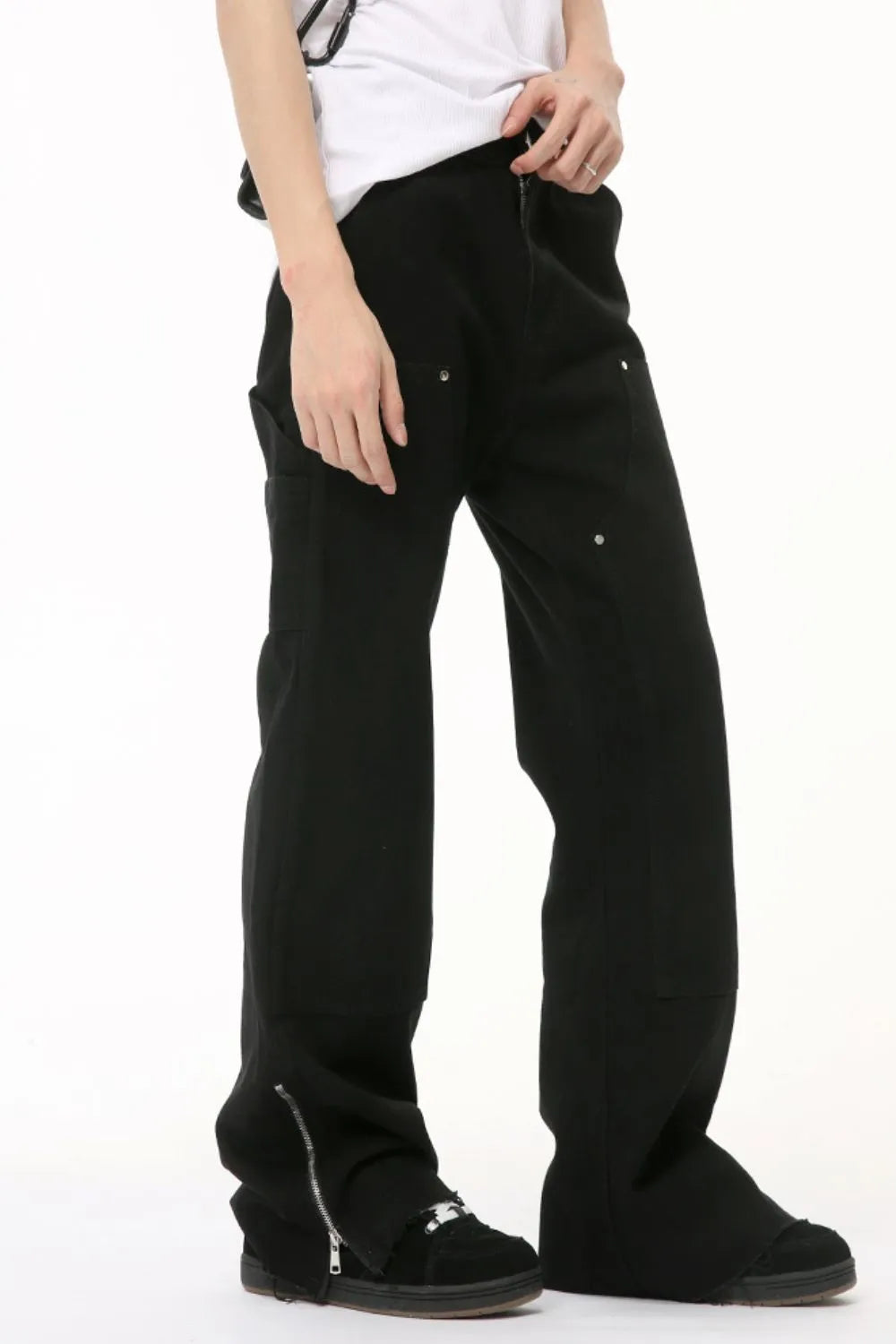 Black bootcut denim pants with zip hem detail and utility pockets
