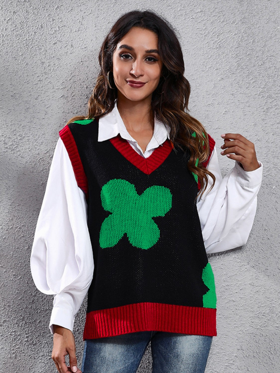 Black acrylic knit vest with green clover intarsia pattern and red trim