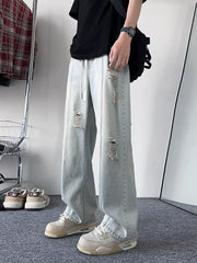 Oversized light blue distressed wide-leg jeans with drawstring waist.