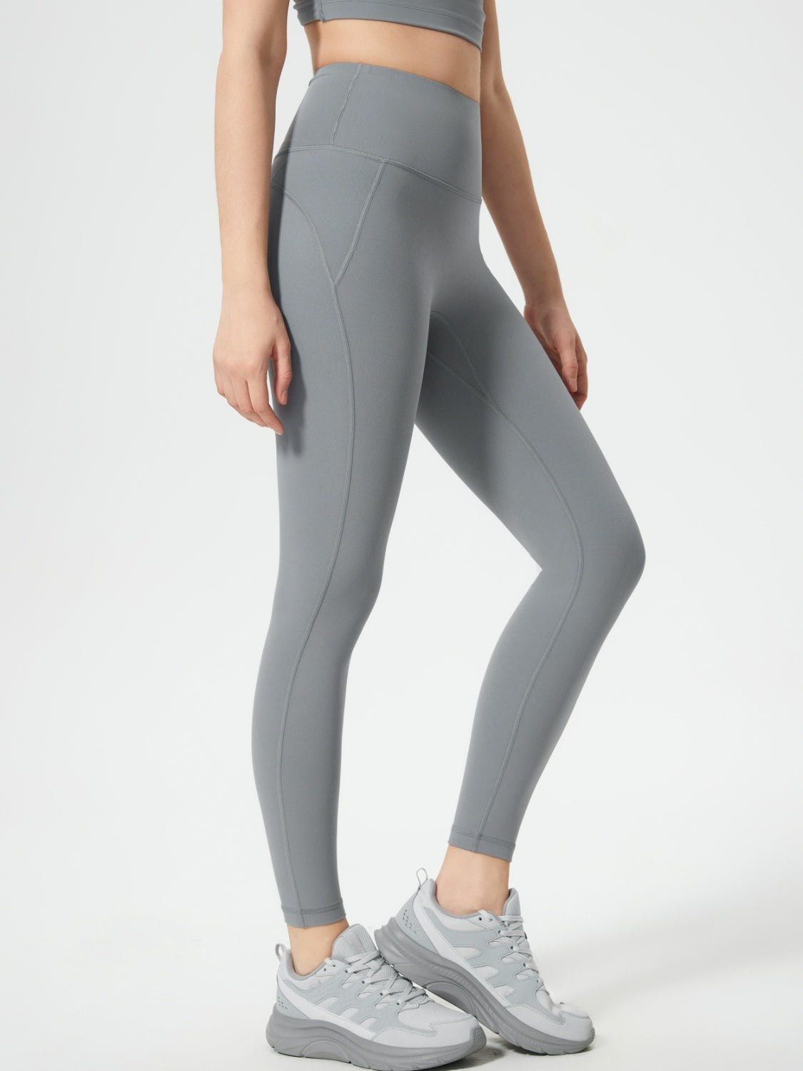 Gray sculpted contour leggings with pocket detail and athletic shoes.