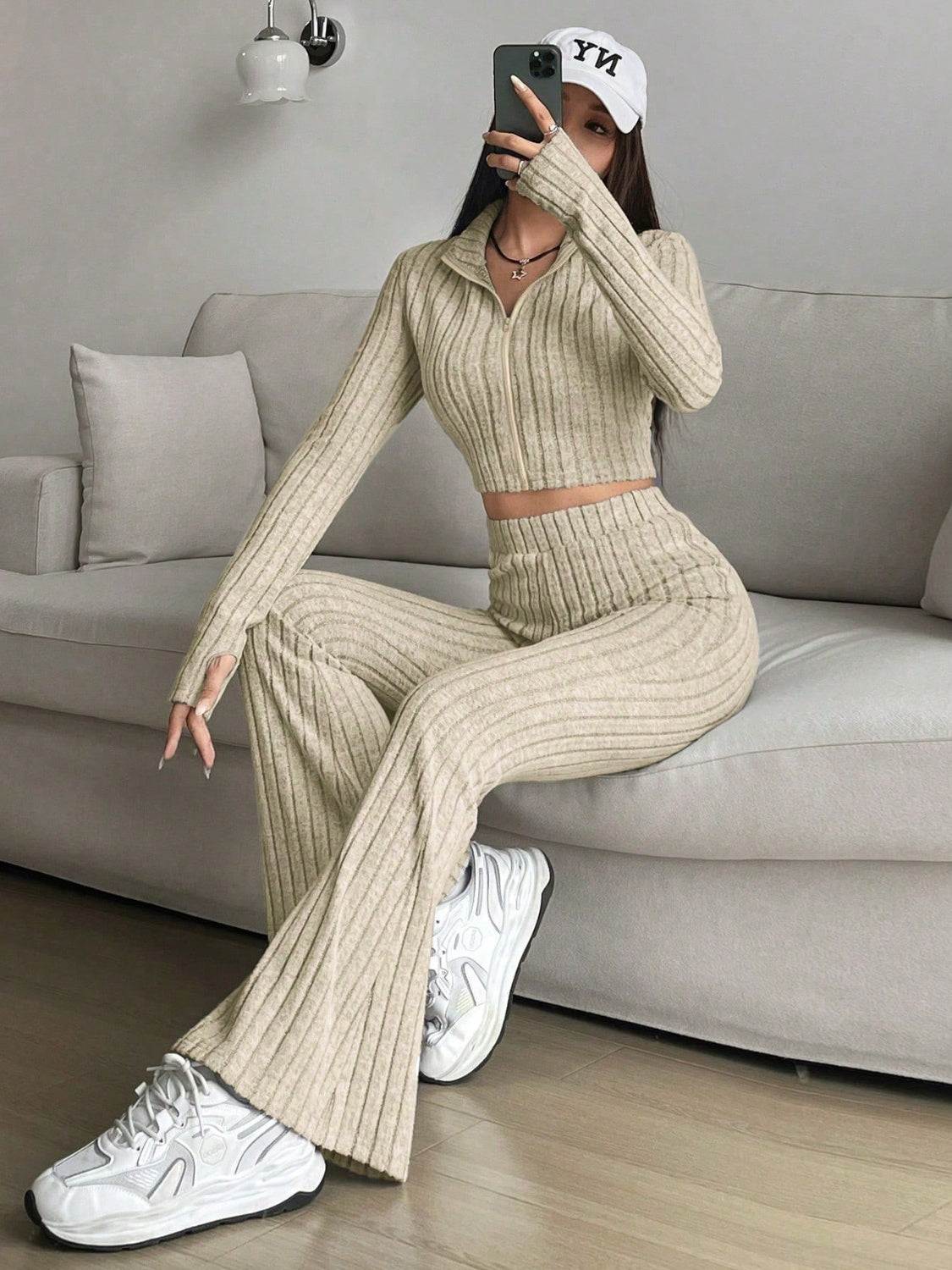 Khaki ribbed knit flare co-ord set with zip-up crop top and wide leg pants.