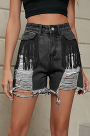 Black denim shorts with fringe pockets and distressed rips.