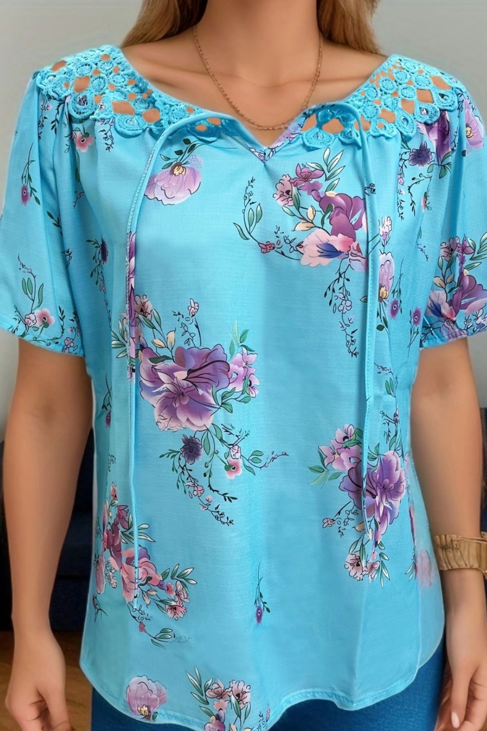 Blue floral tie-neck blouse with lace yoke detail