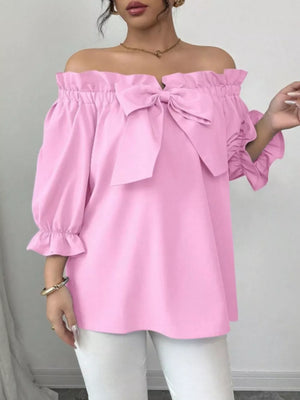 Pink off the shoulder blouse with ruffled neckline and bow detail, 3/4 sleeves.