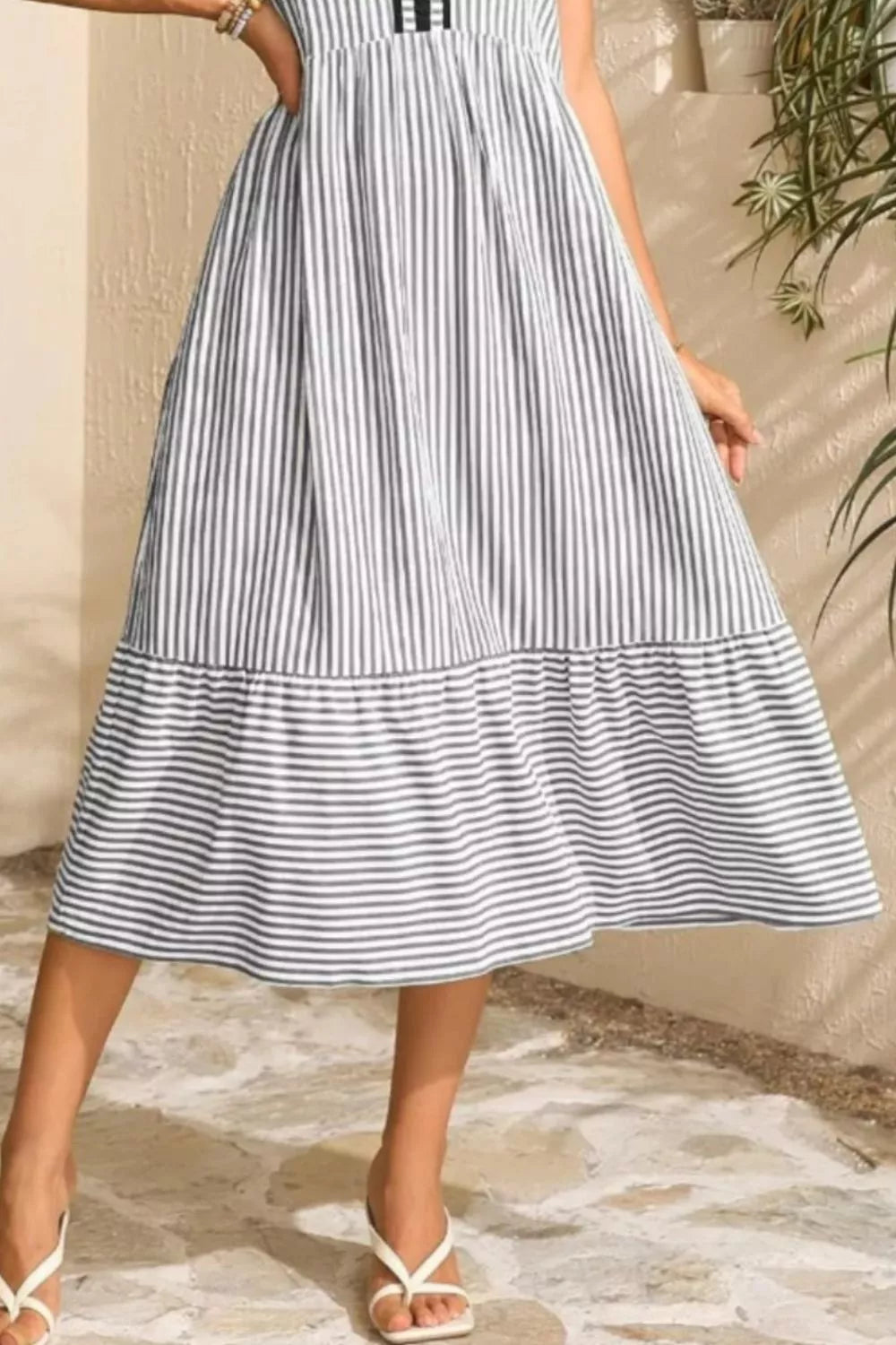 Striped midi dress with ruffle hem and sleeveless design